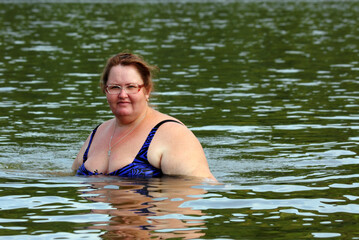 Fototapeta premium plump woman bath in river body positive