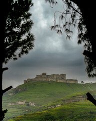 Krak des Chevaliers medieval crusader castle in Syria, a world heritage site. - obrazy, fototapety, plakaty