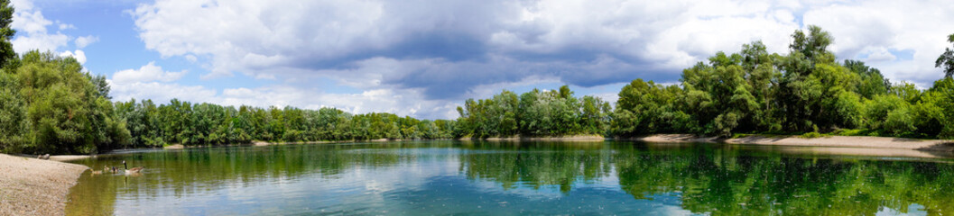 Fototapeta na wymiar Fishing lake near Schwetzingen in Baden-Württemberg. Clear lake with the surrounding nature. 