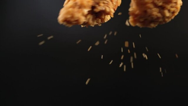 Freeze motion close up in two deep fried chicken pieces