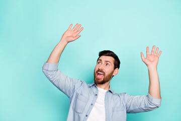 Photo of guy look empty space up panic big horror incredible bargain isolated on cyan color background