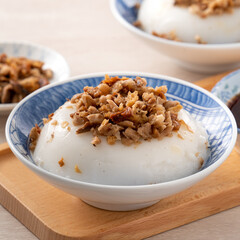 Taiwanese savory rice pudding Wa gui with chopped dried radish and soy sauce