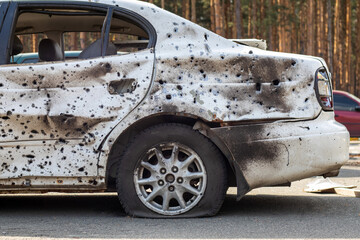 Shot, damaged cars during the war in Ukraine. The vehicle of civilians affected by the hands of the...