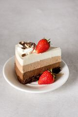 Delicious Cake with Three Different Kind of Chocolate Decorated with Berry and Cream Modern Dessert Gray Background Vertical