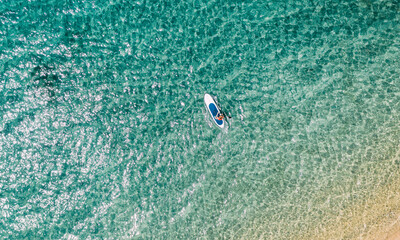 Aerial view of woman paddling stand up paddle