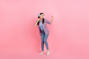 Full body photo of good mood charming lady enjoy dancing in nightclub with headset isolated on pink color background