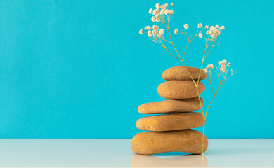 Stack of pebbles stone on colored background for spa, meditation and zen theme.