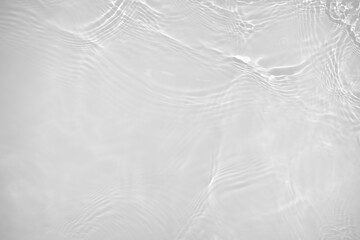 Fototapeta na wymiar Desaturated transparent clear water surface texture with ripples, splashes Abstract nature background. White-grey water waves overlay Copy space, top view. Cosmetic moisturizer micellar toner emulsion