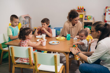 group of kids having lunch in kindergarden