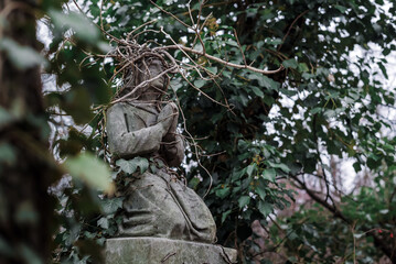 Statue of Praying Jesus on Old European Cemetery