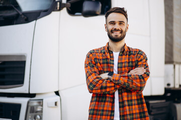 Man trucker smiling and standing by the lorry