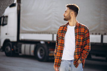 Man trucker happy, standing by the lorry
