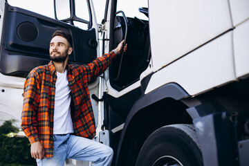 Man trucker happy, standing by the lorry cabin