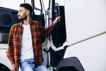 Man trucker happy, standing by the lorry cabin