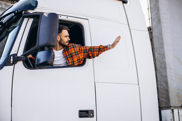 Man trucker sitting in a cabin and looking through the window