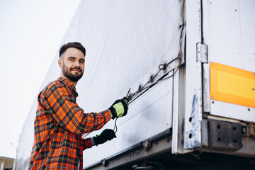 Man trucker standing by his truck