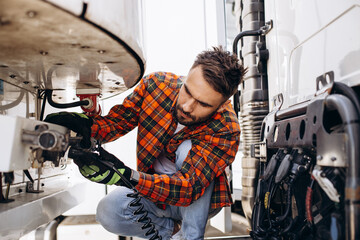 Man trucker checking elements in his truck