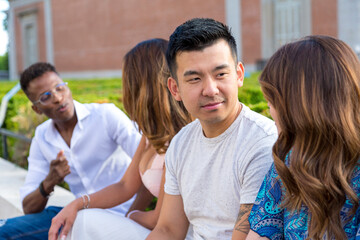 chinese young man with friends sitting outdoor