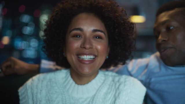 Zoom Out Portrait of Black Couple Laughing Out Loud, while Watching Comedy at the TV During the Evening. Diverse Boyfriend and Girlfriend Talk with Each Other. Slow Motion