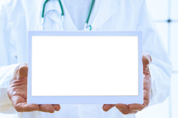 doctor with a stethoscope holds a tablet in his hands with an empty space. For text