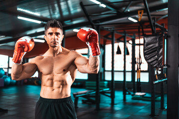 Handsome brutal strong boxer man in boxing gloves.boxing champion in pose.