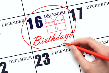 The hand circles the date on the calendar 16 December, draws a gift box and writes the text Birthday. Holiday.