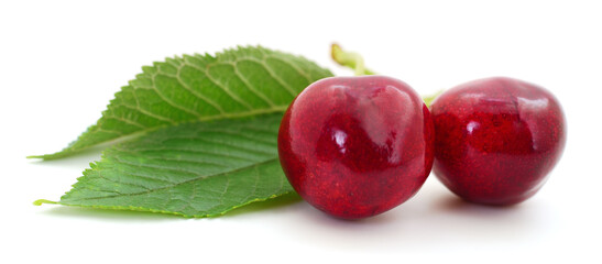 Fototapeta na wymiar Sweet cherries with stem and leaves.