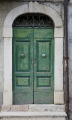 Fototapeta na wymiar Old Green Wooden Door in Central Italy Rural Village