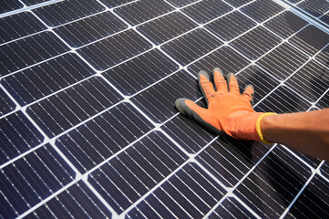 Close up of man solar technician installing solar modules for generating electricity through...
