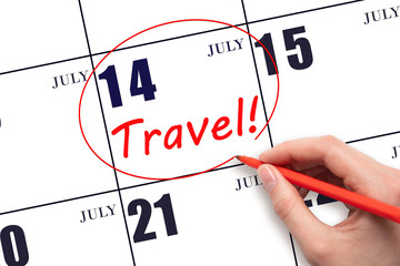 Hand drawing a red circle and writing the text TRAVEL on the calendar date 14July. Travel planning.