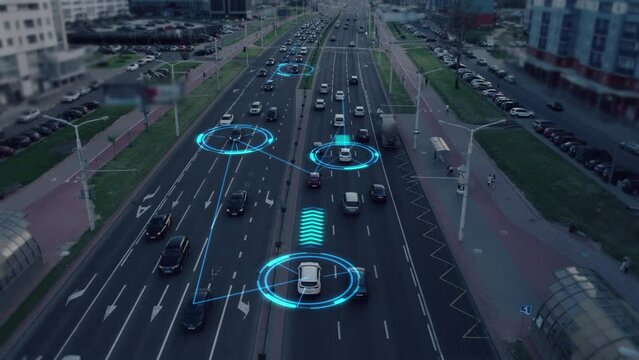 Autonomous self-driving driverless cars of the future, controlled by a system with artificial intelligence, move along a busy city street, scanning with sensors the road situation and distance. UHD 4K