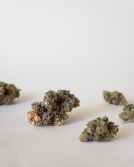 Dried and trimmed cannabis buds. Green marijuana buds with light natural background