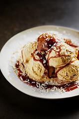 Vanilla ice cream with caramel sauce and coconut