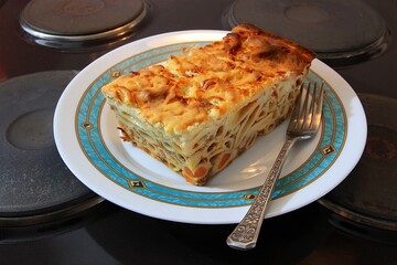 Pasticcio Greek macaroni pie pasta dish with ground meat and bechamel sauce. Selective focus