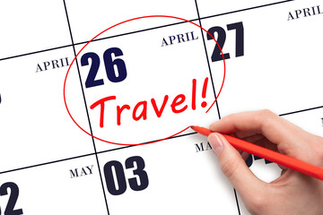 Hand drawing a red circle and writing the text TRAVEL on the calendar date 26 April. Travel...