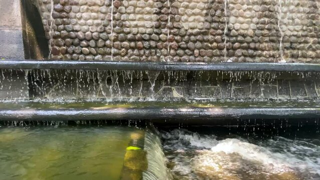dirty water from the nezahualcoyotl fountain flowing by gravity towards mexico city