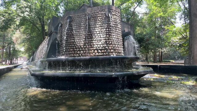 slow motion video of the water flowing from the fountains of the chapultepec forest towards mexico city