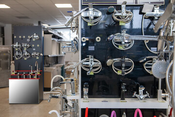Kitchen faucets on shelf closeup, plumbing shop