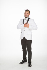 a kind man in a white jacket with a bow tie poses with positive emotions. cheerful man in the studio on a white background isolated shows a range of positive emotions