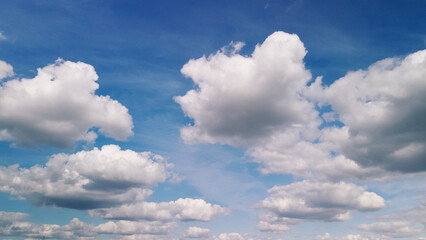 Fluffy clouds on the blue sky. Drone panning.