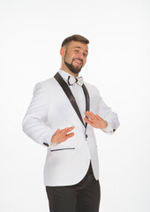 a kind man in a white jacket with a bow tie poses with positive emotions. cheerful man in the studio on a white background isolated shows a range of positive emotions