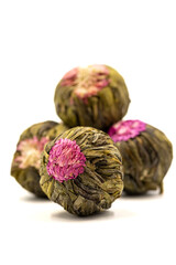 Obraz premium Jasmine tea balls isolated on white background. Flowering tea or blooming tea. close up