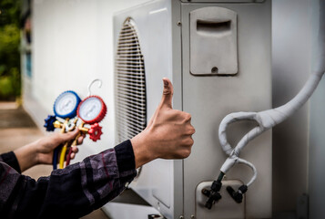 Air conditioner technician checking air conditioner operation