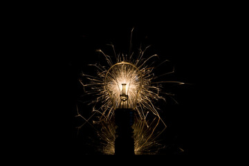 The incandescent lamp burns with sparks - obrazy, fototapety, plakaty