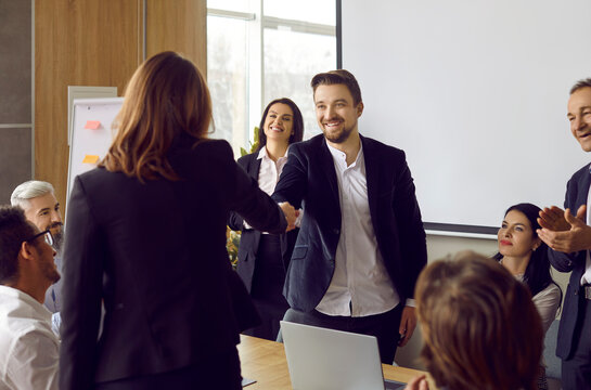 Smiling diverse businesspeople shake hands get acquainted at meeting in office. Business clients or partners handshake close deal or make agreement after successful negotiations. Collaboration.