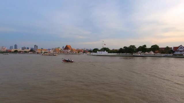 View of the Buddhist temple Wat Kalayanamit Woramahawihan by the Chao Phraya River in the evening on sunset, Bangkok, Thailand