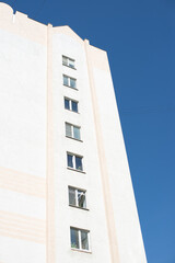 Residential multi-storey building against the blue sky