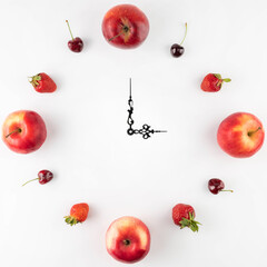 On a white background, a watch with a dial of fruits and berries.