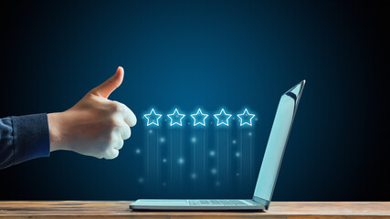 The concept of five stars. The best rating on the Internet. Hand showing thumbs up in front of...