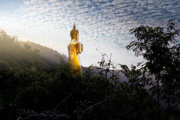 Statue of the golden Buddha at Phra That In Hang, Lampang, Thailand.